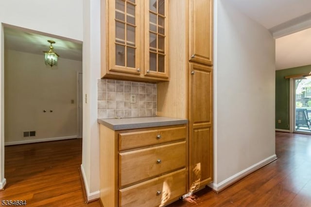 interior space with visible vents, baseboards, and dark wood-type flooring