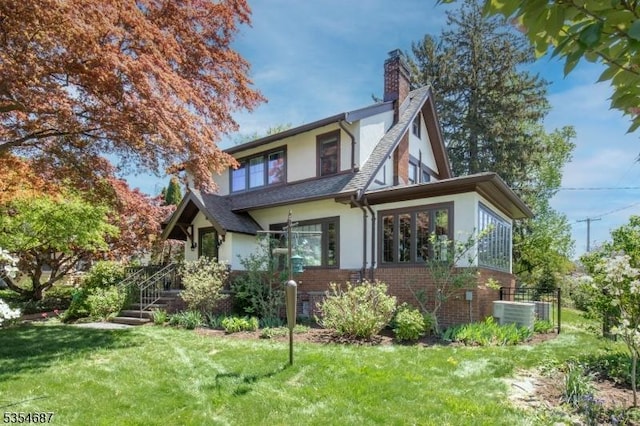 1 Ambar Pl, Bernardsville Boro, NJ 07924 - view of front of house featuring stucco siding, a chimney, brick siding, a front lawn, and central air condition unit