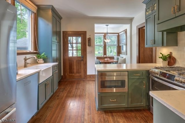 1 Ambar Pl, Bernardsville Boro, NJ 07924 - kitchen with appliances with stainless steel finishes, green cabinets, a sink, light countertops, and backsplash
