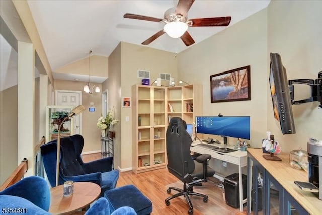 home office with a ceiling fan, vaulted ceiling, and wood finished floors