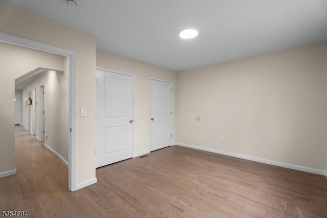 unfurnished bedroom featuring baseboards and wood finished floors