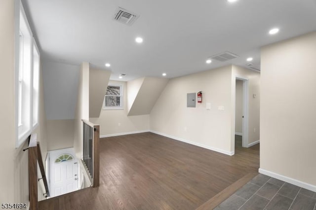 additional living space featuring recessed lighting, baseboards, visible vents, and dark wood finished floors