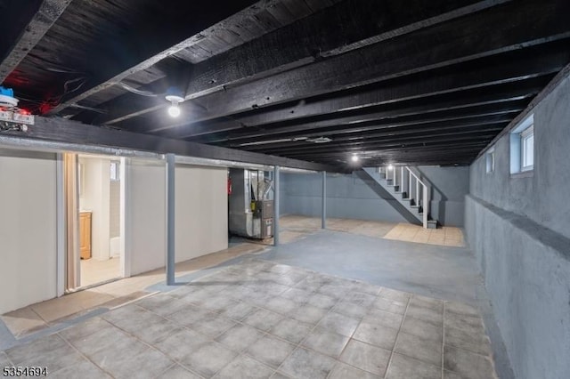 below grade area with heating unit and stairway