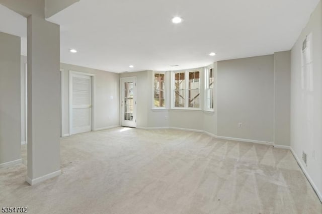 interior space featuring baseboards, light carpet, and recessed lighting