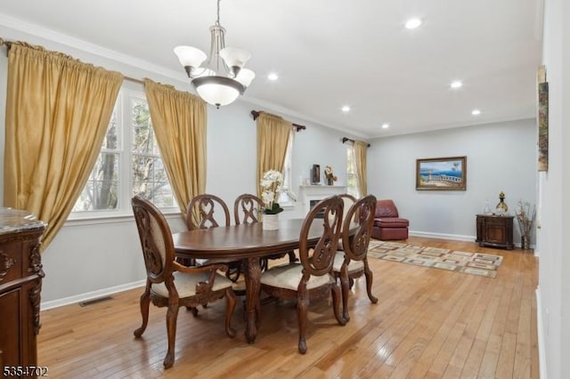 dining room featuring recessed lighting, baseboards, a notable chandelier, and light wood finished floors