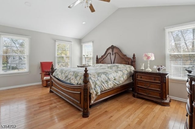 bedroom featuring baseboards, a ceiling fan, vaulted ceiling, and light wood-style flooring