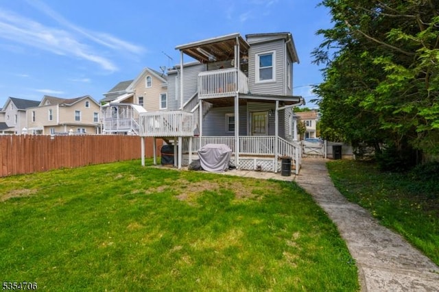 rear view of property with a balcony and a residential view