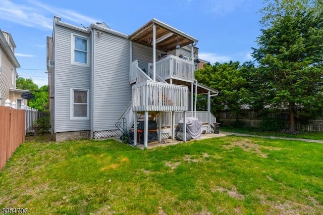 rear view of house featuring a balcony and stairway