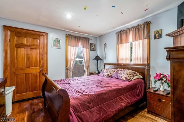 bedroom with wood finished floors and recessed lighting