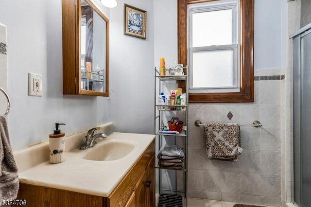 bathroom with vanity and a shower with shower door
