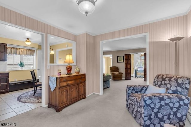 living area with light carpet, a baseboard heating unit, and wallpapered walls