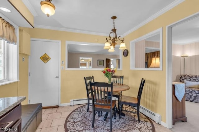dining space featuring crown molding, baseboards, and a baseboard heating unit