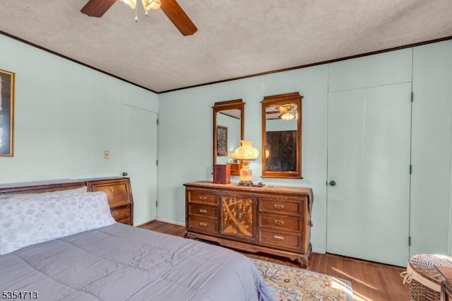 bedroom featuring a ceiling fan and wood finished floors