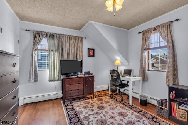 office space featuring crown molding, baseboard heating, a textured ceiling, and wood finished floors