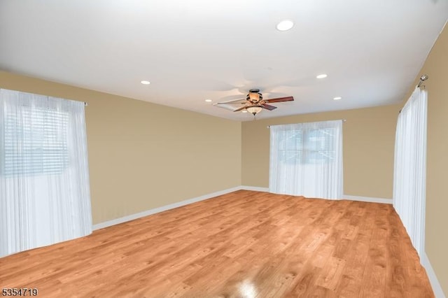 unfurnished room featuring recessed lighting, light wood-style flooring, ceiling fan, and baseboards
