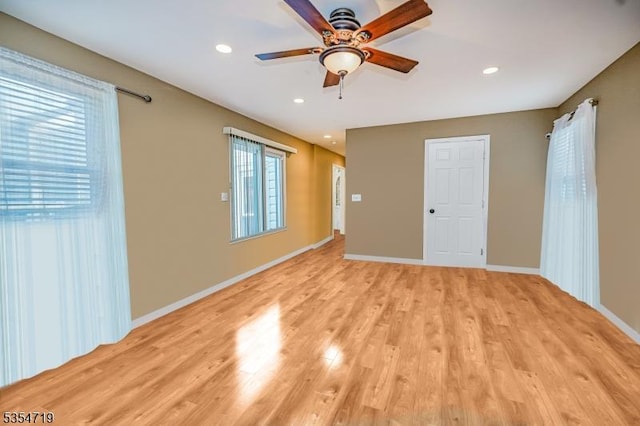 unfurnished room with a ceiling fan, baseboards, recessed lighting, and light wood-style flooring