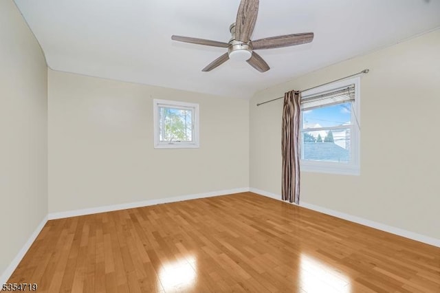 unfurnished room featuring light wood-style floors, baseboards, and ceiling fan