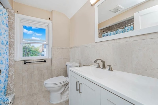 full bath featuring vanity, curtained shower, toilet, tile walls, and tile patterned floors