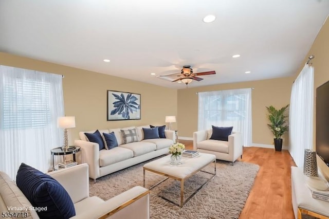 living room with recessed lighting, light wood-style floors, ceiling fan, and a healthy amount of sunlight