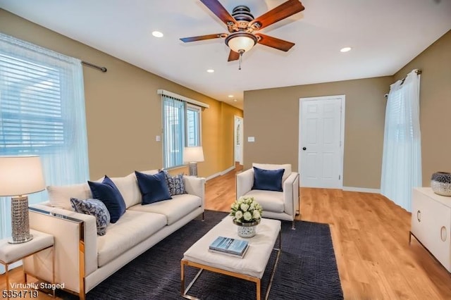 living area with light wood-style floors, baseboards, ceiling fan, and recessed lighting
