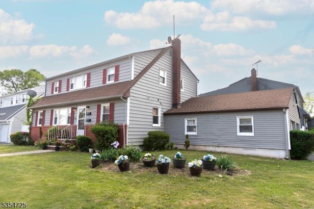 1263 Biscayne Blvd, Union Twp, NJ 07083 - view of front facade featuring roof with shingles, a front lawn, and a chimney