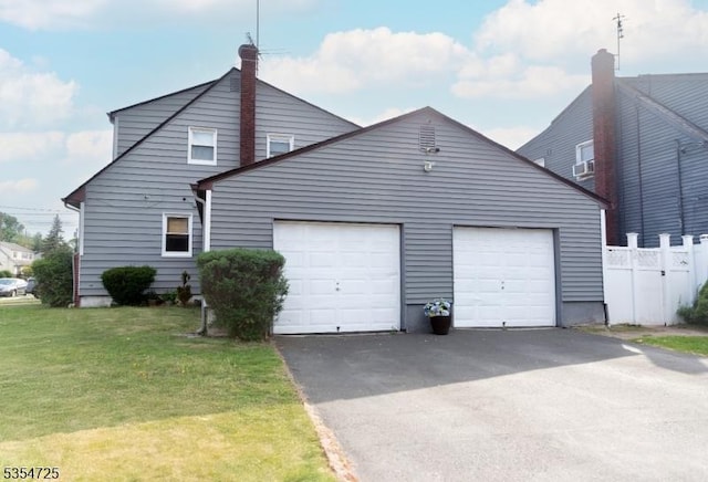 1263 Biscayne Blvd, Union Twp, NJ 07083 - view of front facade featuring a chimney, fence, a garage, a front yard, and aphalt driveway