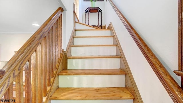 staircase featuring ornamental molding