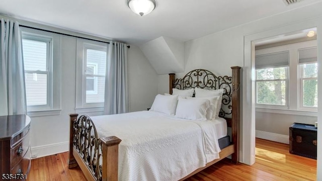 bedroom featuring baseboards and light wood-style flooring