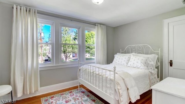 bedroom featuring baseboards, dark wood finished floors, and visible vents