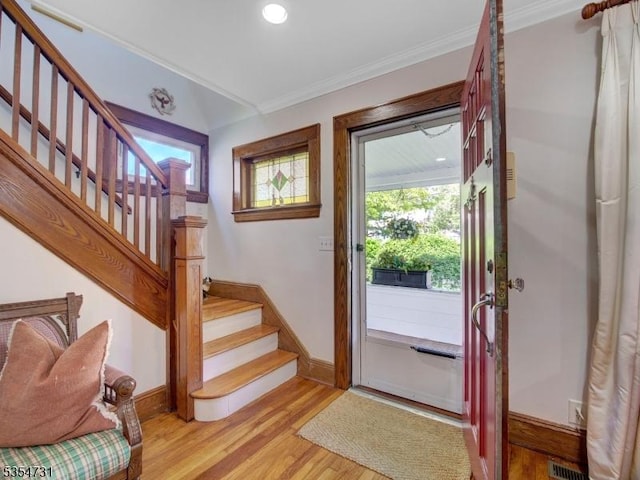 doorway to outside with a healthy amount of sunlight, baseboards, light wood finished floors, and stairs