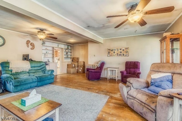 living room featuring ceiling fan, ornamental molding, and wood finished floors
