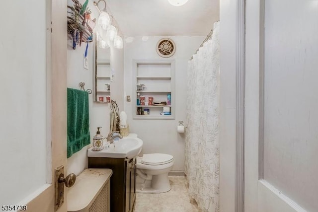bathroom featuring vanity, tile patterned flooring, and toilet
