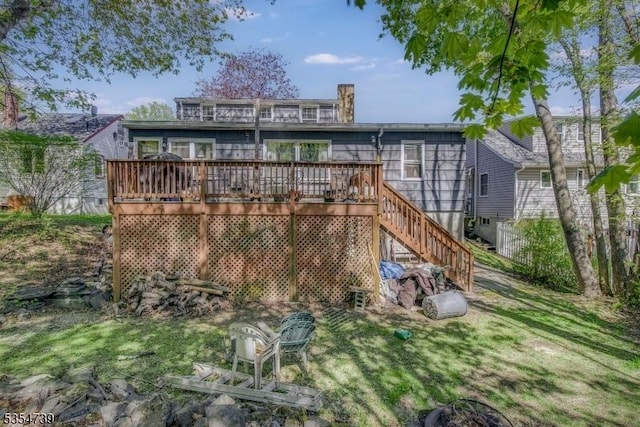 rear view of property featuring a wooden deck and stairs