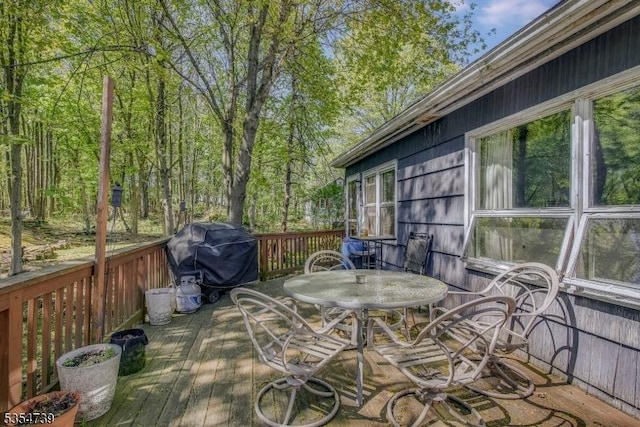 wooden deck featuring outdoor dining area and area for grilling
