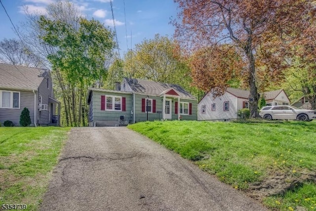 ranch-style home with a front lawn and driveway