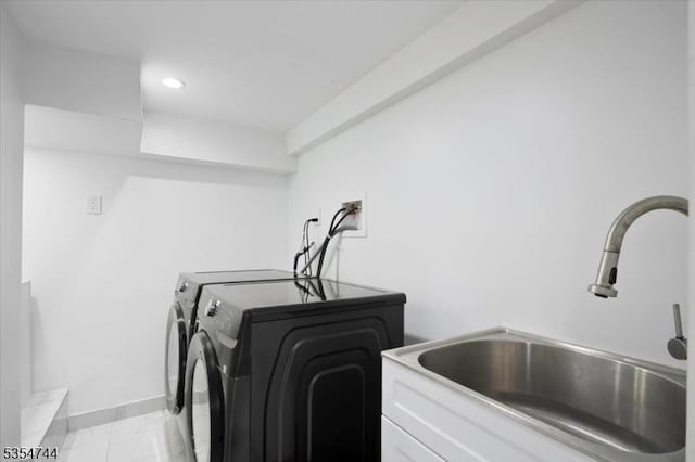 clothes washing area with laundry area, a sink, baseboards, recessed lighting, and washer and dryer