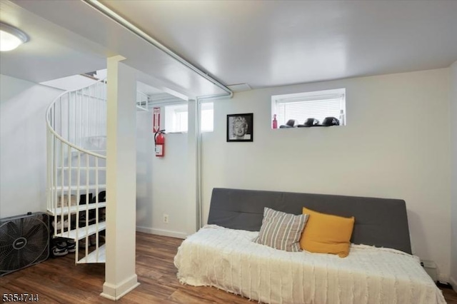 interior space featuring baseboards and wood finished floors
