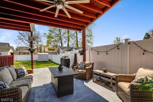 view of patio with a fenced backyard, a ceiling fan, and outdoor lounge area