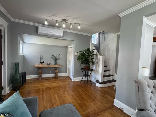 foyer entrance with stairs, crown molding, wood finished floors, and a wall mounted air conditioner