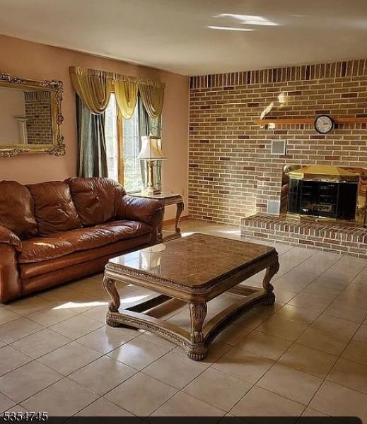 305 Old York Rd, Raritan Twp, NJ 08822 - tiled living area featuring brick wall and a fireplace