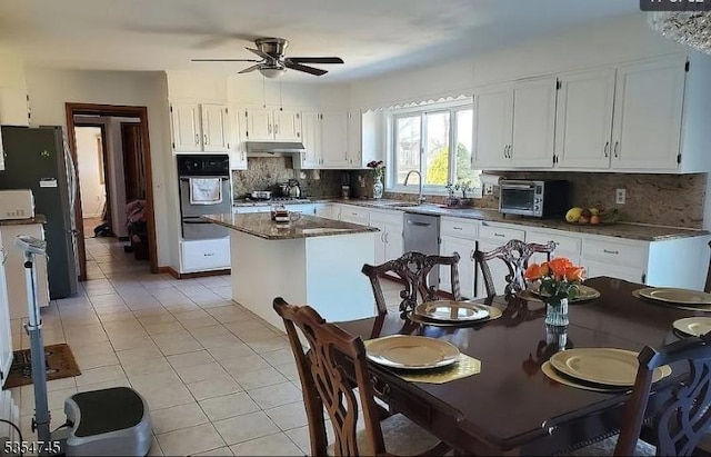 305 Old York Rd, Raritan Twp, NJ 08822 - kitchen with a center island, a ceiling fan, black oven, and light tile patterned flooring