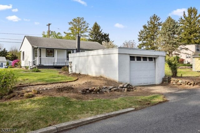 202 Parkside Ave, Pohatcong Twp, NJ 08865 - view of front of property featuring covered porch, asphalt driveway, and a front lawn