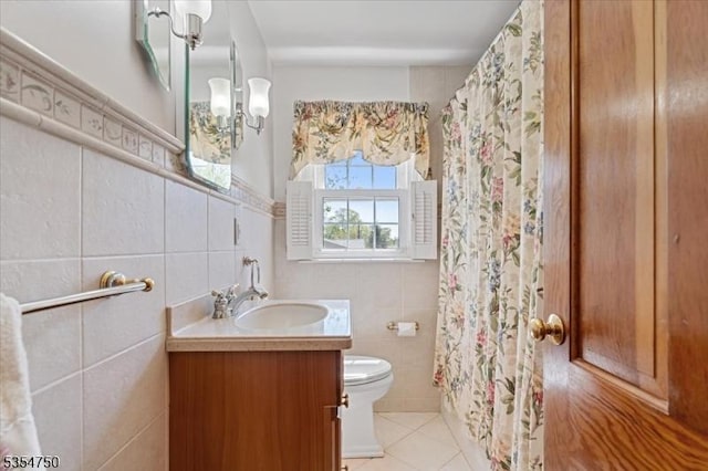 full bath featuring a shower with curtain, tile walls, tile patterned floors, vanity, and toilet