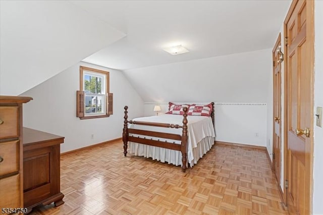 bedroom with baseboards and vaulted ceiling