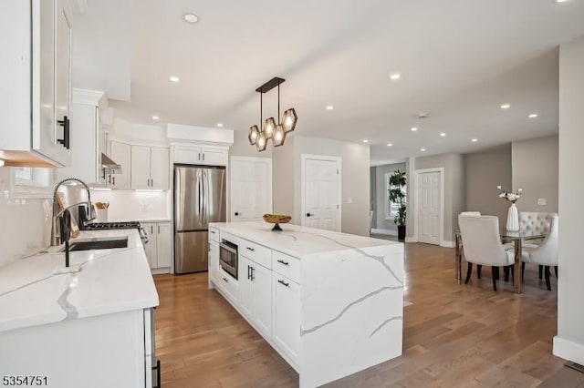 223 Victor St, Scotch Plains Twp, NJ 07076 - kitchen featuring a center island, a sink, white cabinetry, and stainless steel appliances