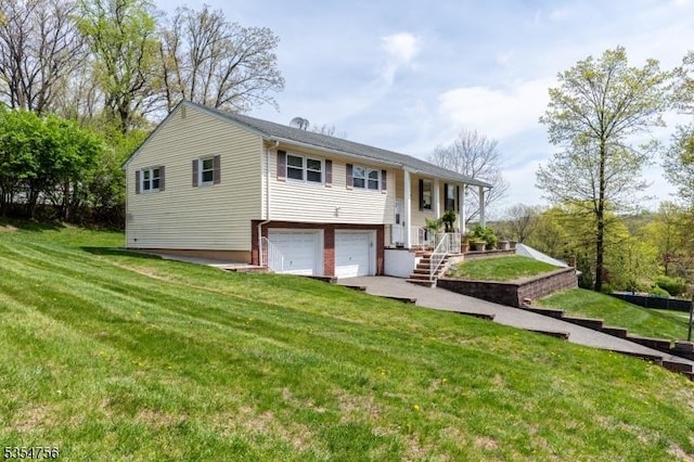 bi-level home featuring an attached garage, stairs, and a front yard