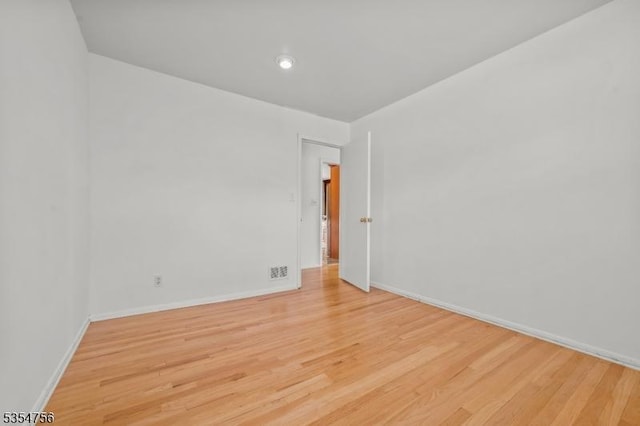 empty room featuring recessed lighting, baseboards, visible vents, and light wood-style floors