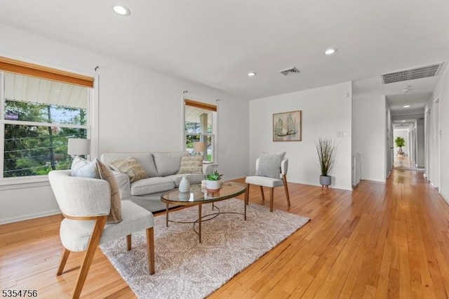 living area featuring recessed lighting, visible vents, and light wood-style floors