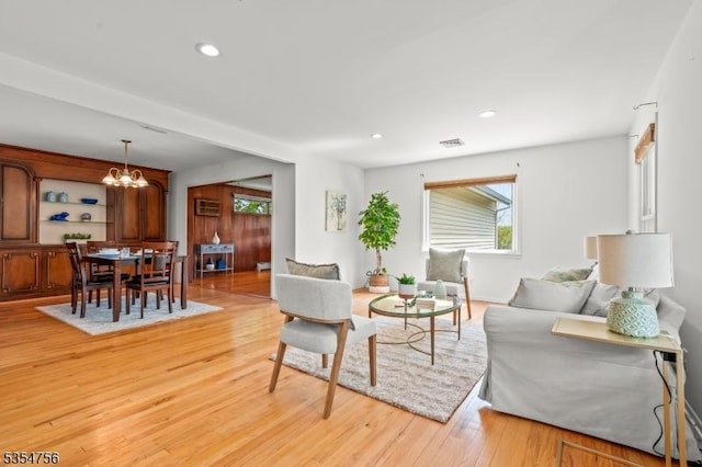 living room with a chandelier, visible vents, recessed lighting, and light wood finished floors