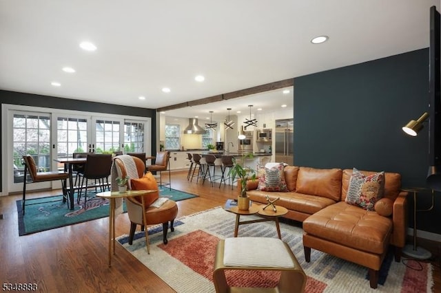 living area featuring baseboards, recessed lighting, and wood finished floors